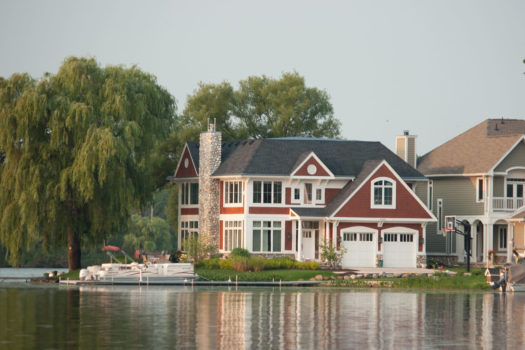 View of two story lake house from the water.